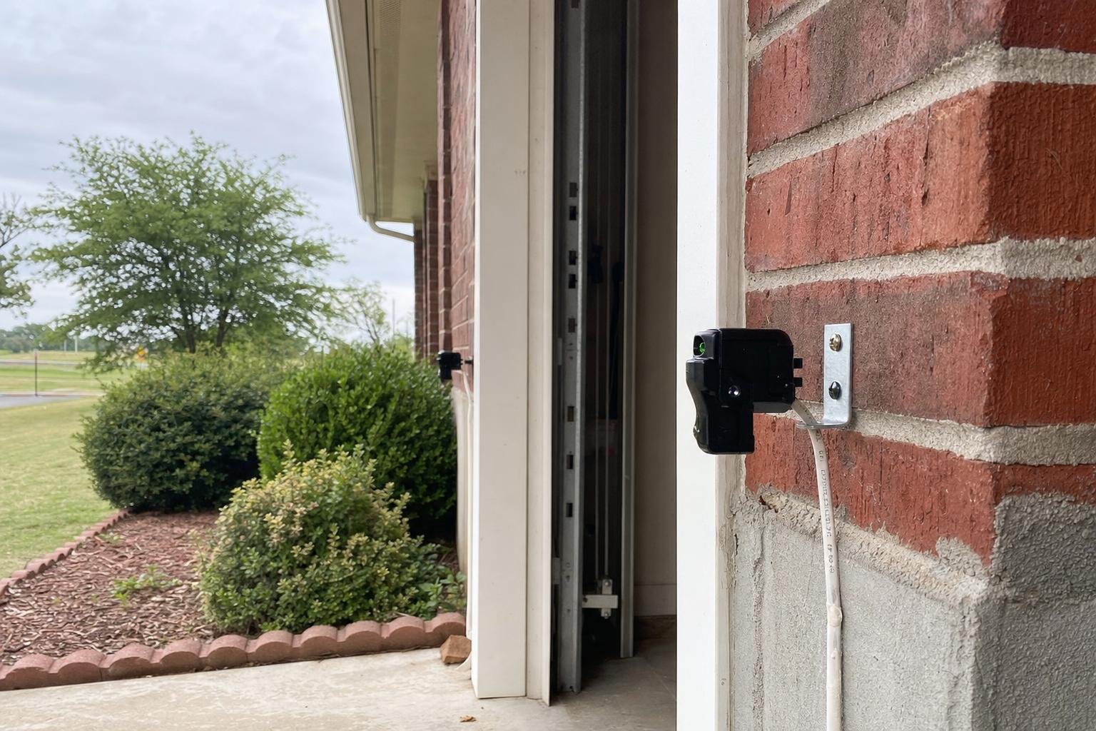 Illustrative image of garage door safety sensor repair work